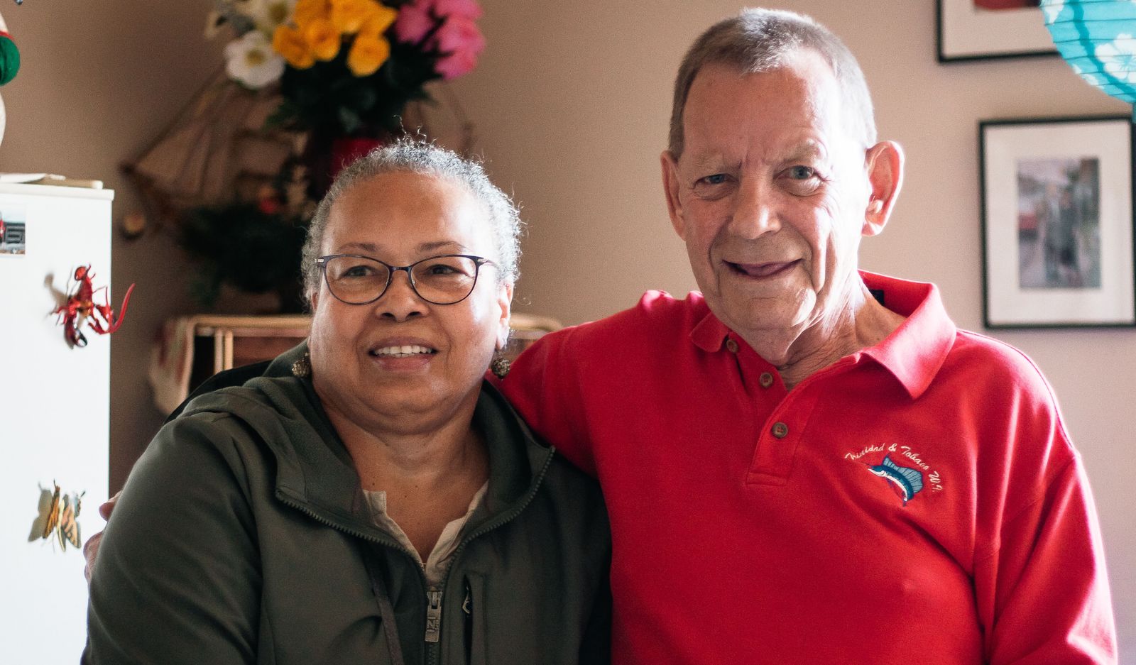 smiling elderly man and woman in apartment