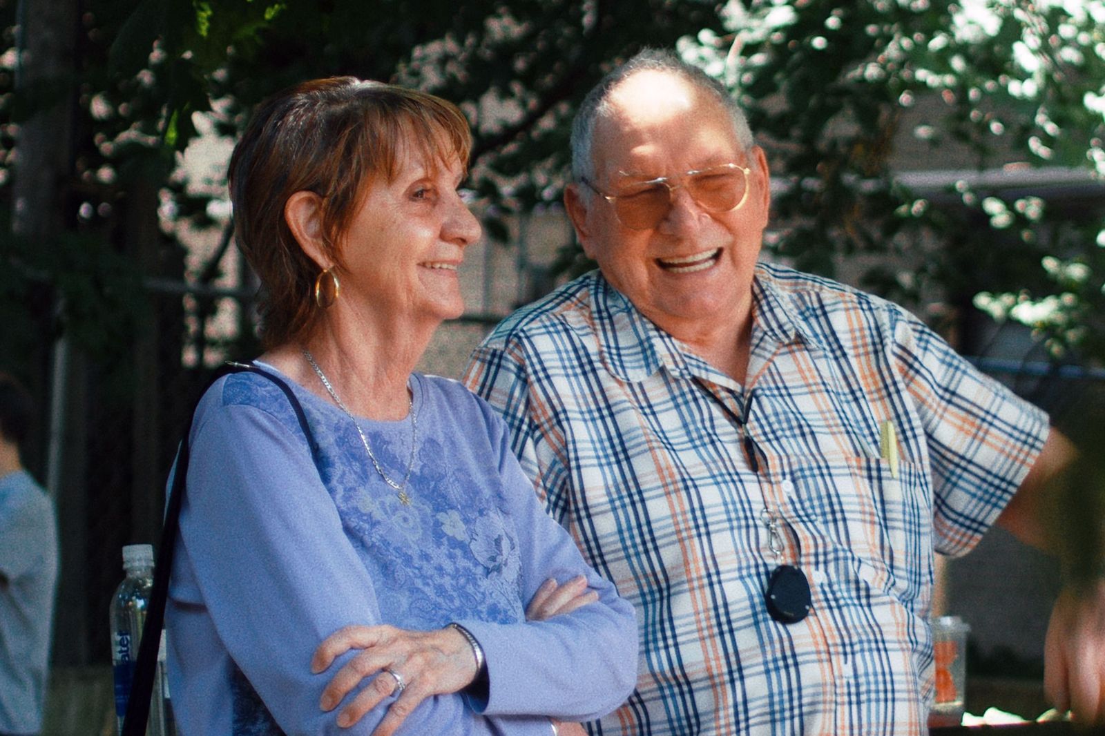 elderly man and woman standing outside talking