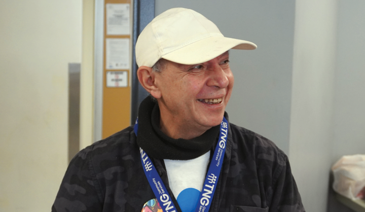 smiling man wearing TNG lanyard