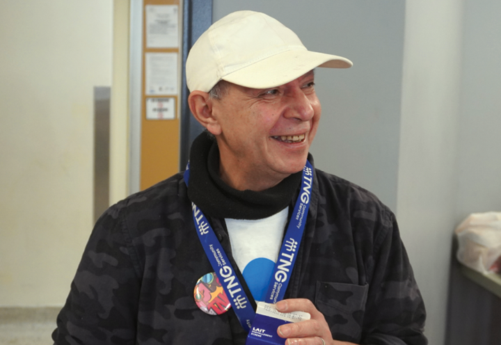 smiling man wearing TNG lanyard