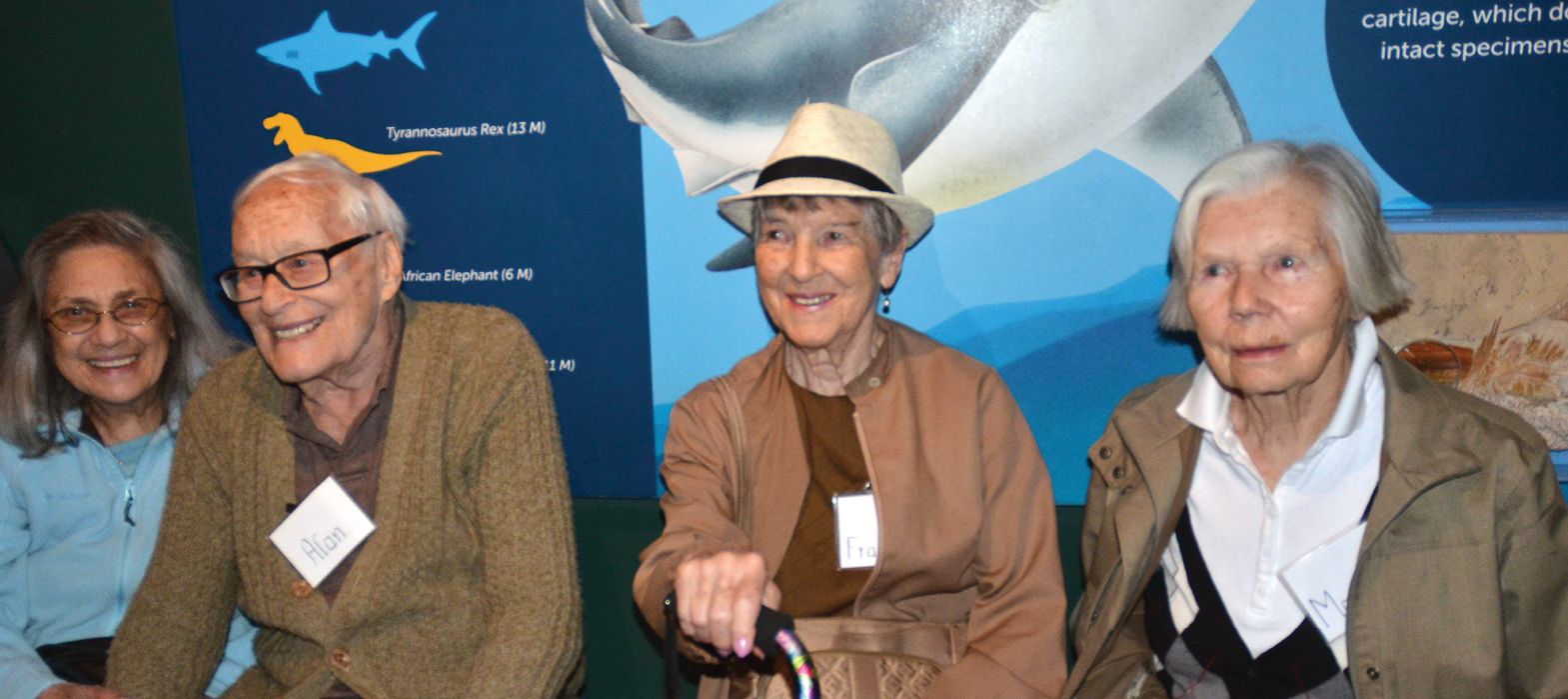 group of smiling seniors on a trip to the Aquarium