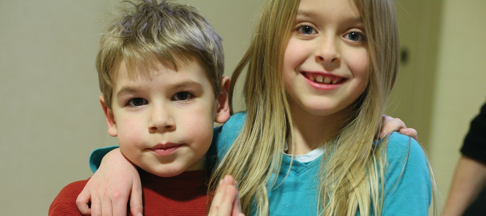 boy and girl hugging for camera
