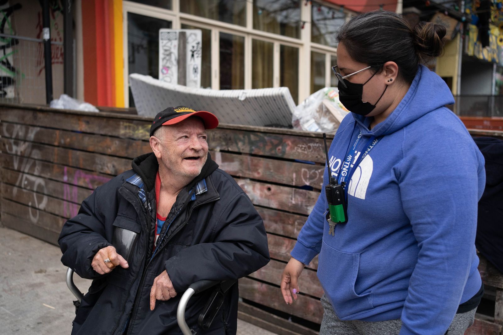 old man talking to employee