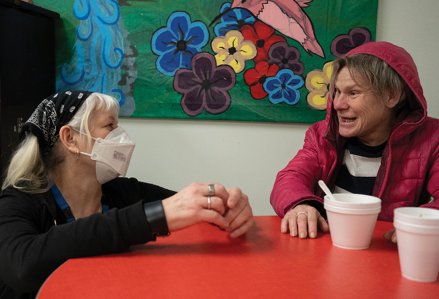staff member and woman talking