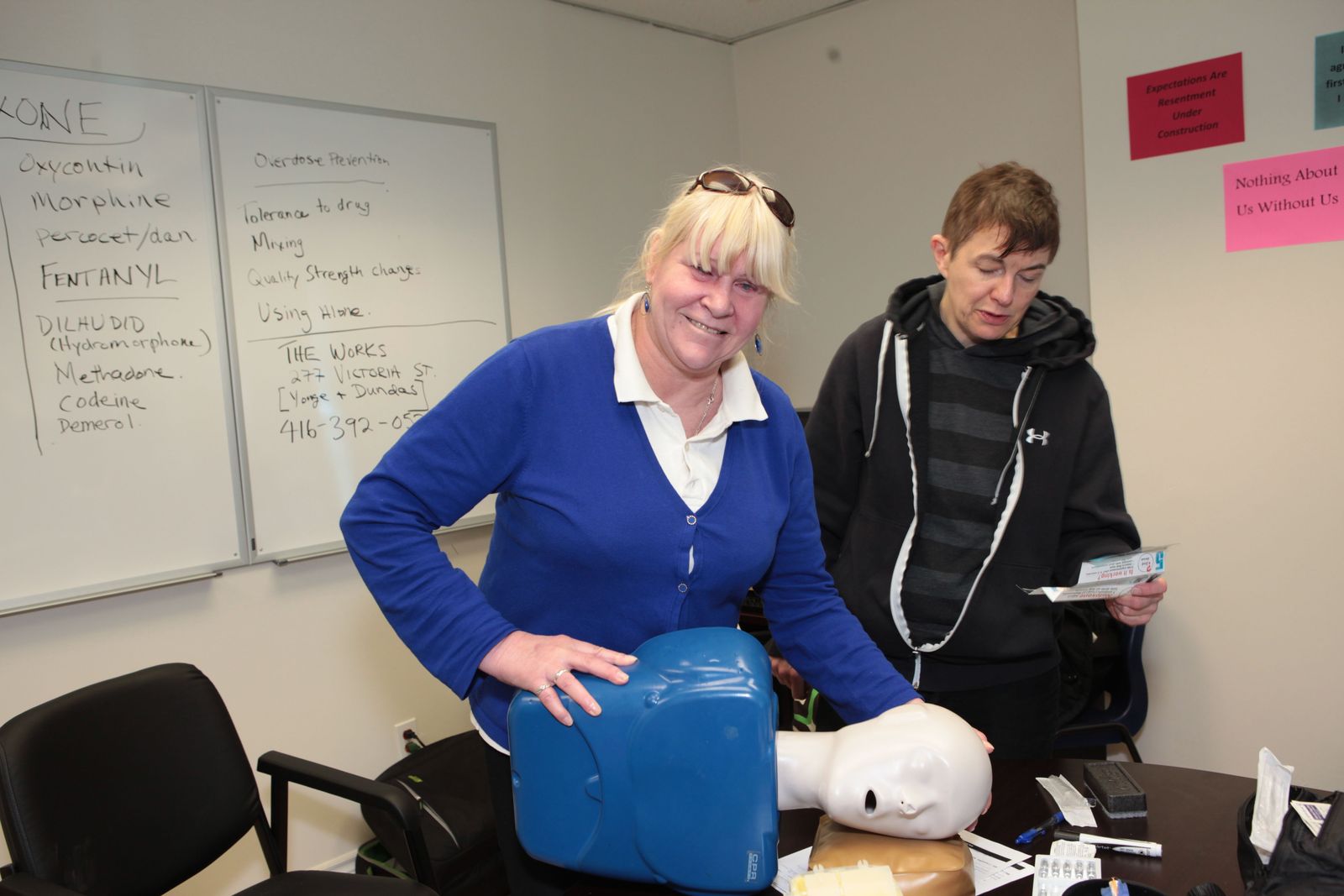 smiling woman practicing first aid and CPR