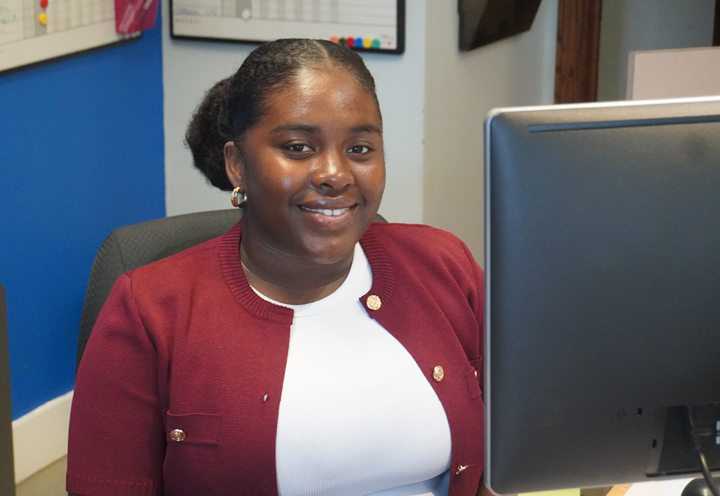 smiling young woman working at a computer