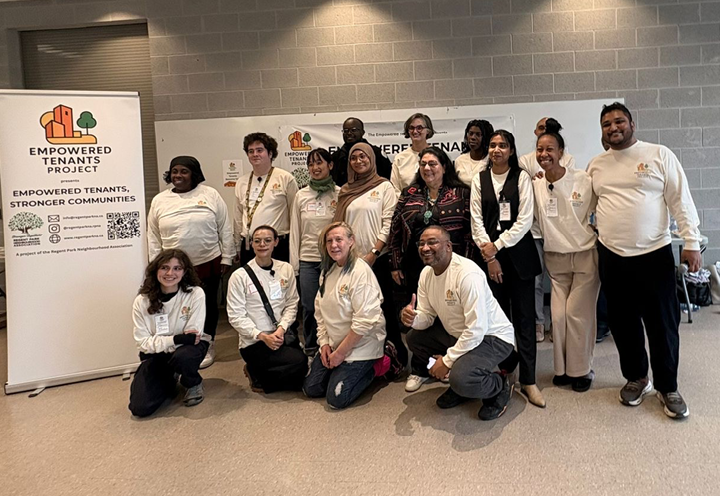 group of people standing in front of a sign that reads "Empowered Tenants Project"