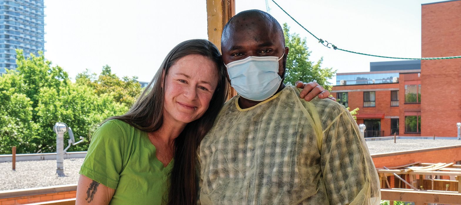 woman hugging a man in a mask
