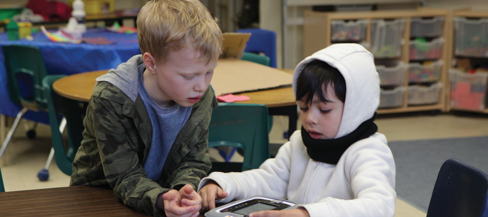 two children playing at a desk