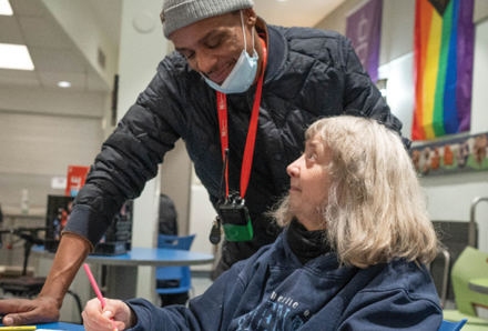 staff talking to smiling woman