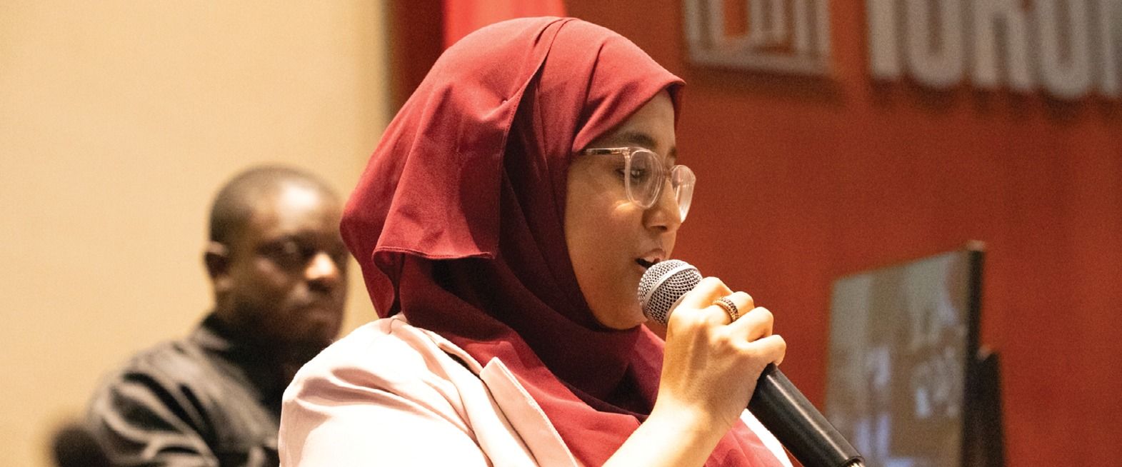 young woman speaking at summit