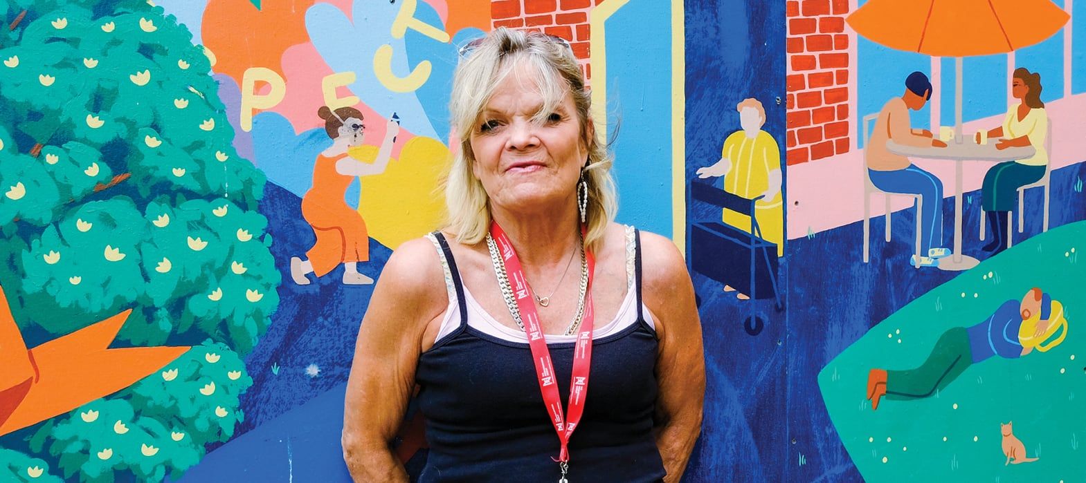 woman standing in front of mural