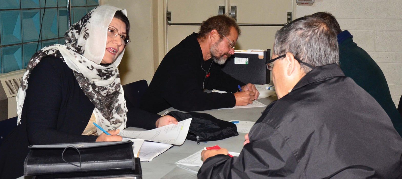 people working with staff to get identification