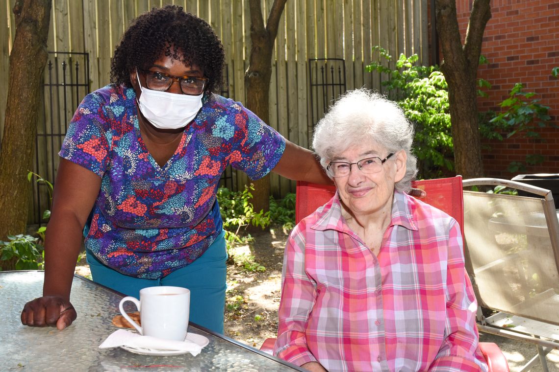 elderly woman sitting with a personal support worker