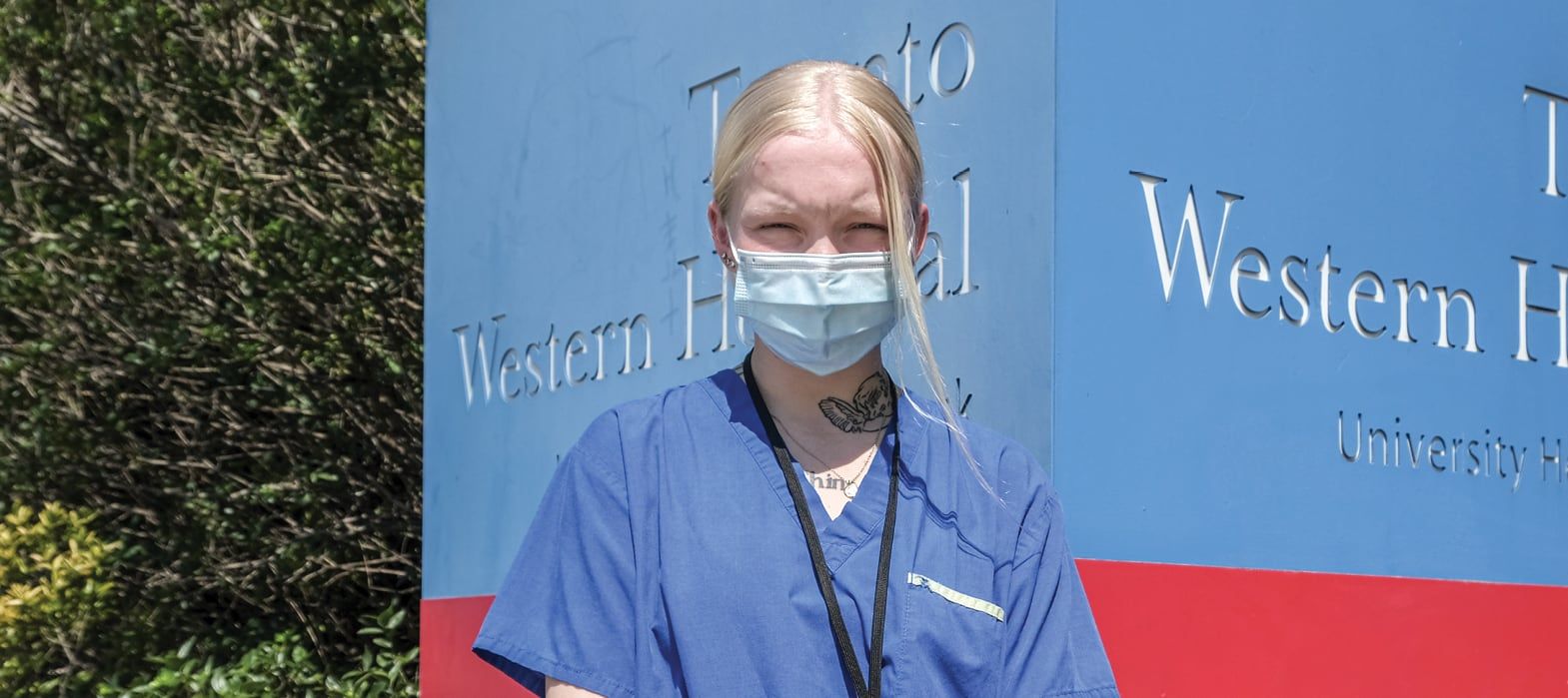woman standing in front of Emergency Room sign