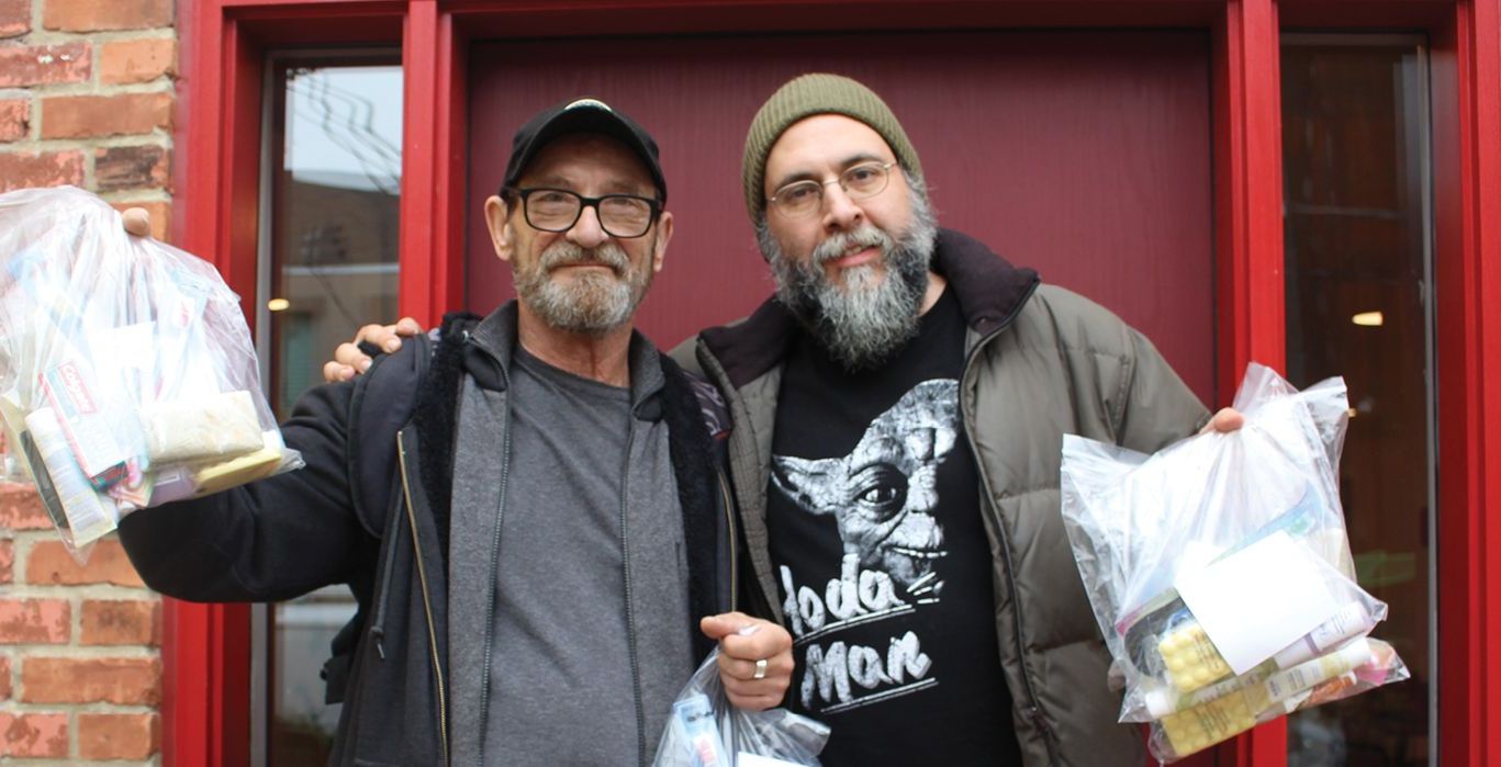 two men standing in front of a door