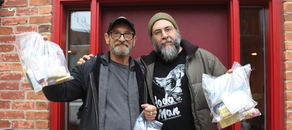 two men standing in front of a door