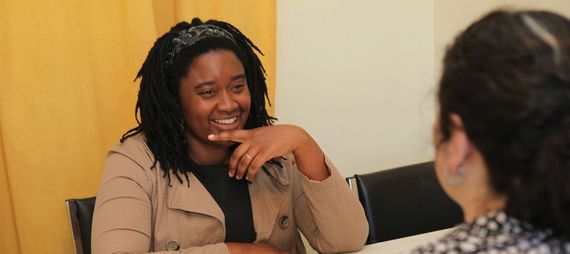 smiling woman talking to another person
