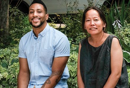 smiling man and woman sitting outside