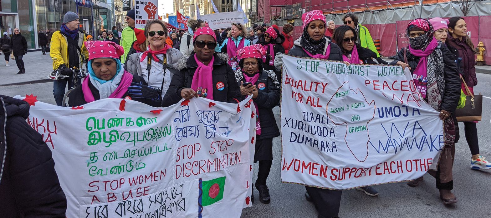 people on streets walking and holding messages